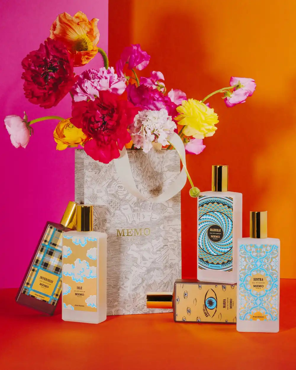 Perfume bottles and floral arrangement.