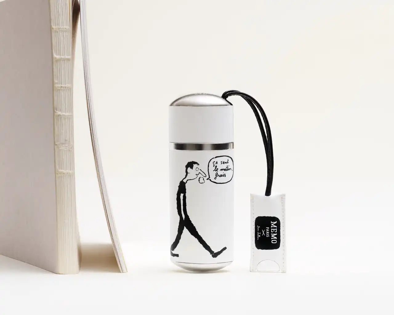 White thermal bottle with a black cartoon drawing.