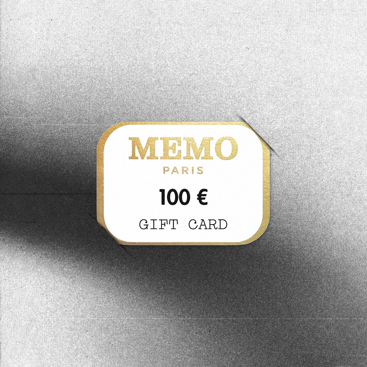 A white and gold memo paris gift card with elegant embossed lettering and 100 euro value celebrating dream destinations — vue alternative