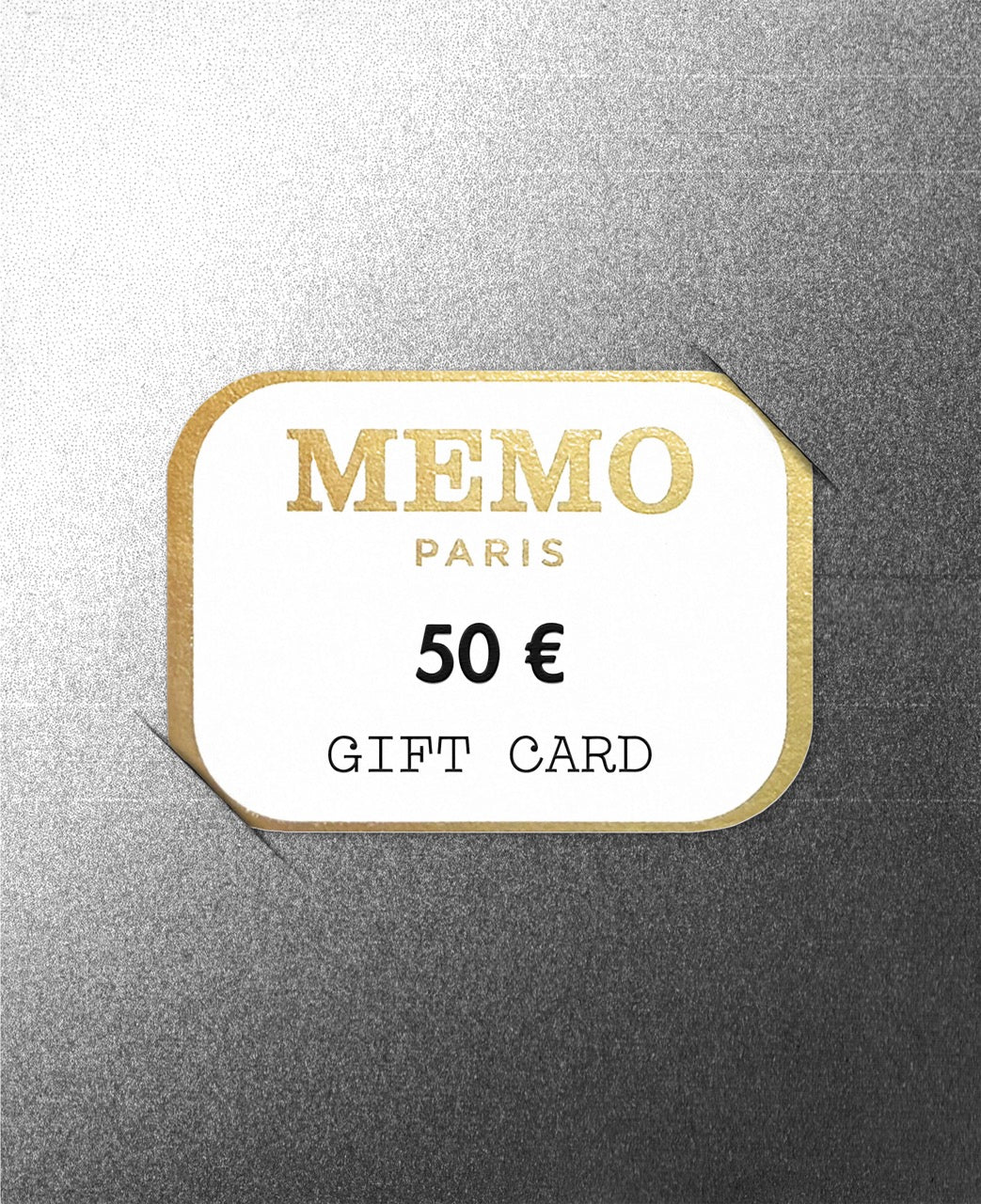 A white rectangular memo paris gift card with gold foil lettering and border celebrating dream destinations worth 50 €